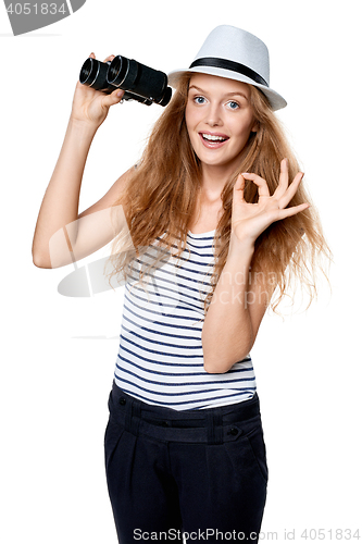 Image of Female with binoculars gesturing OK