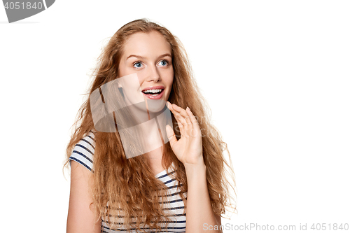 Image of Excited teen girl looking to the side in amazement