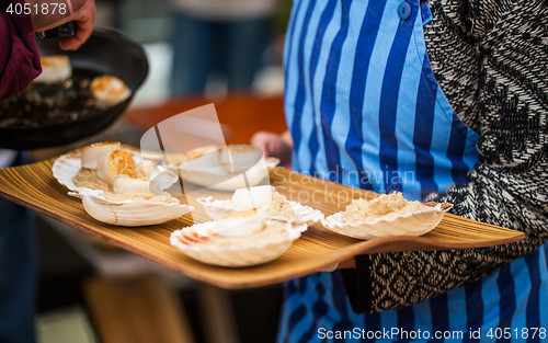 Image of close up of scallop snacks garnish on seashell