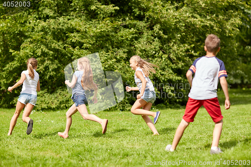 Image of happy kids running and playing game outdoors