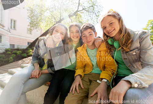 Image of happy teenage students or friends hugging