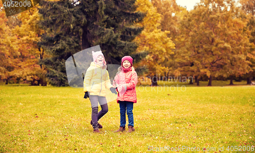 Image of two happy little girls in autumn park