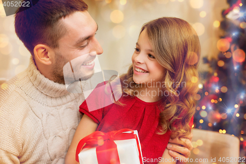 Image of smiling father and daughter looking at each other