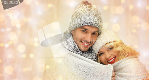 Image of happy family couple in winter clothes hugging