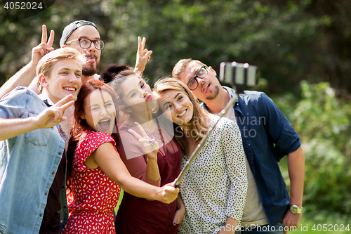 Image of friends taking selfie by smartphone at summer