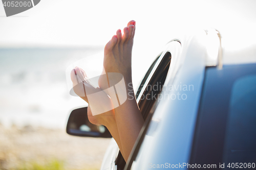 Image of close up of woman feet showing from car window