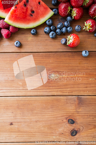 Image of close up of fruits and berries on wooden table