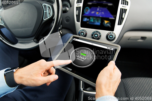 Image of close up of man with tablet pc in car