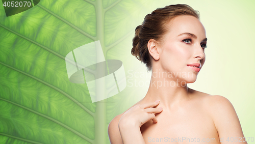 Image of beautiful young woman touching her neck