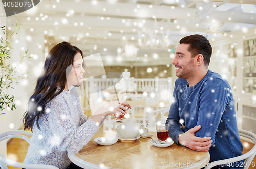 Image of happy couple drinking tea at cafe