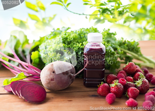 Image of bottle with beetroot juice, fruits and vegetables