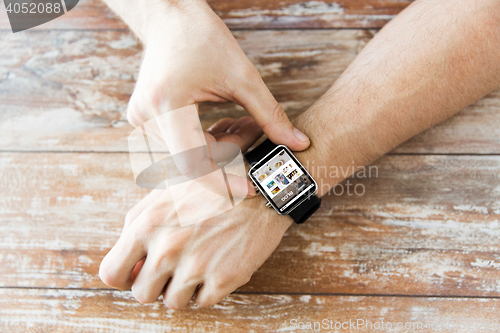 Image of close up of hands with blog on smart watch screen