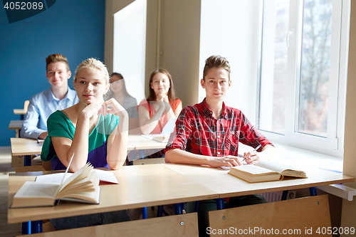 Image of group of students with books at school lesson