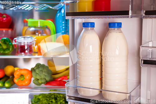 Image of Open refrigerator filled with food