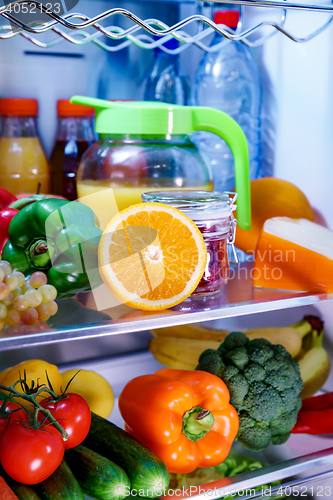 Image of Open refrigerator filled with food