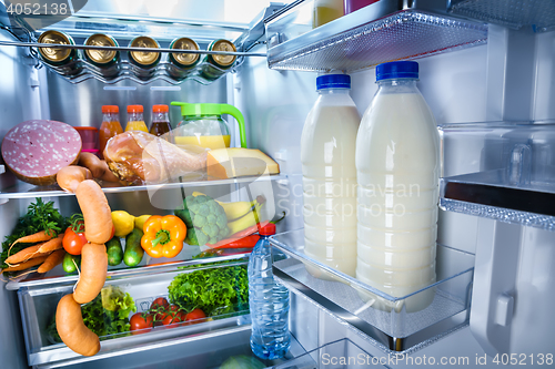 Image of Open refrigerator filled with food