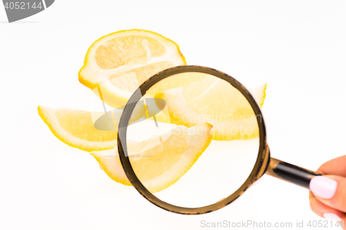 Image of Lemon and a magnifying glass on white background