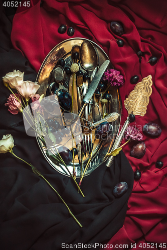 Image of The fruit bowl with grapes and plums in silver plate