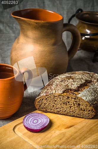 Image of Still life with homemade bread and pottery