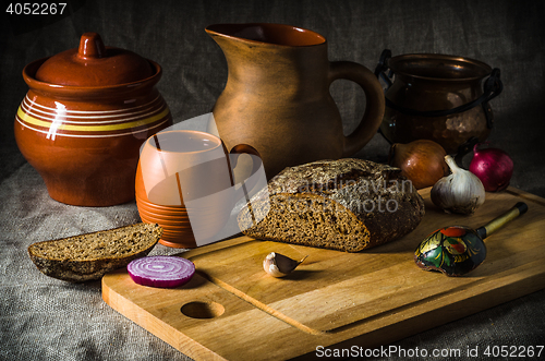 Image of Still life with homemade bread and pottery