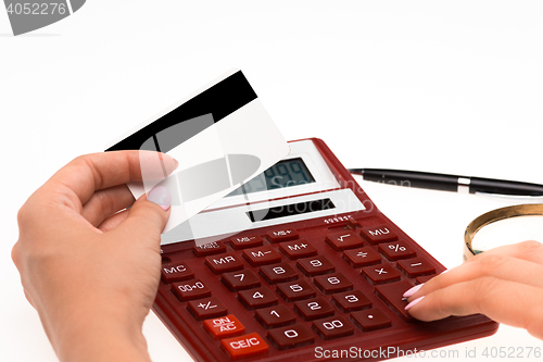 Image of Concept for Internet shopping: hands with calculator and credit card