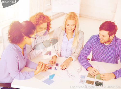 Image of smiling creative team looking at sketch