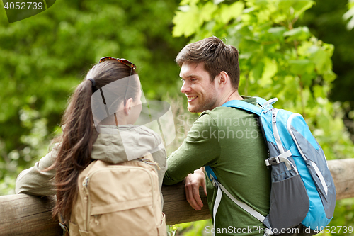 Image of smiling couple with backpacks in nature