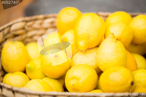 Image of close up of fresh ripe lemons in basket