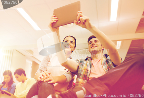 Image of group of smiling students with tablet pc