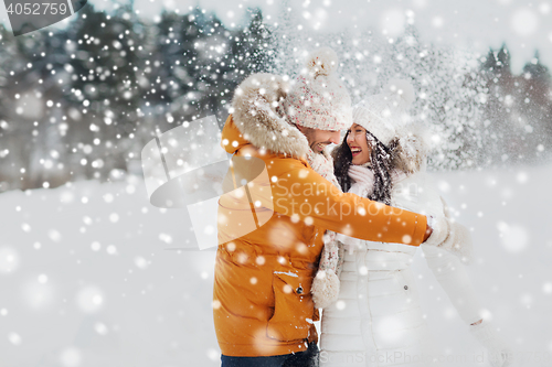 Image of happy couple hugging and laughing in winter