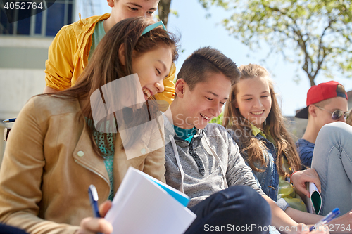 Image of group of students with notebooks at school yard