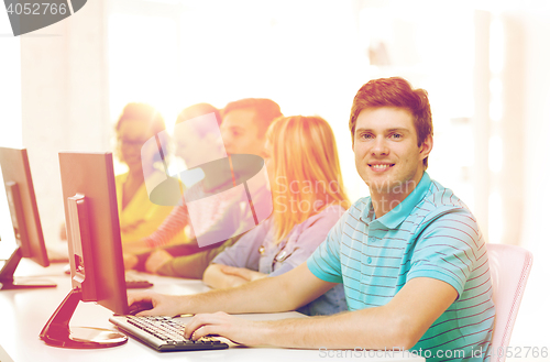 Image of male student with classmates in computer class