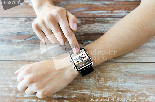 Image of close up of hands with blog on smart watch screen