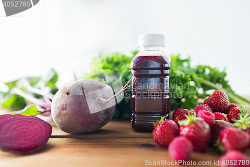 Image of bottle with beetroot juice, fruits and vegetables