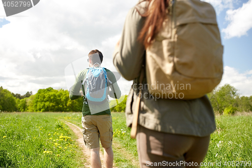 Image of close up of couple with backpacks hiking outdoors