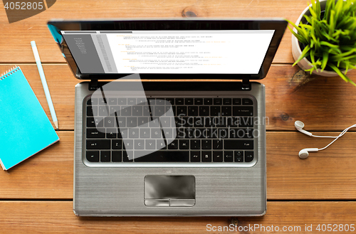 Image of close up of laptop computer on wooden table