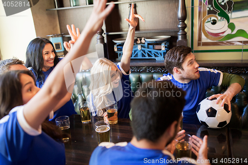 Image of fans or friends watching football at sport bar