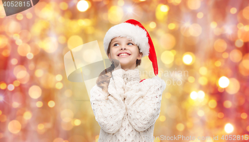 Image of dreaming girl in santa helper hat