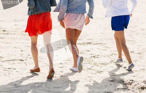 Image of close up of women legs running on beach