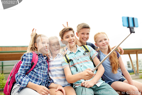 Image of happy elementary school students taking selfie