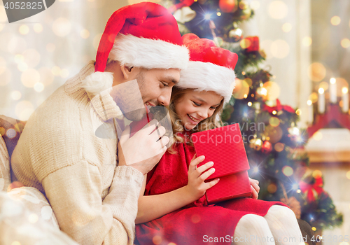 Image of smiling father and daughter opening gift box