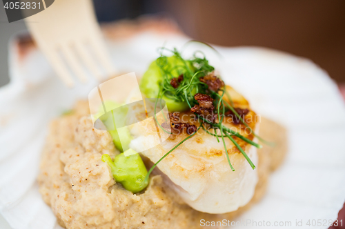 Image of close up of scallop snack with garnish