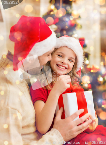 Image of smiling father and daughter opening gift box