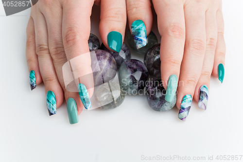 Image of Closeup of woman hands with colorful nails