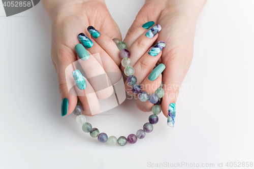 Image of Closeup of woman hands with colorful nails
