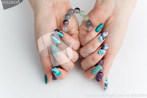 Image of Closeup of woman hands with colorful nails