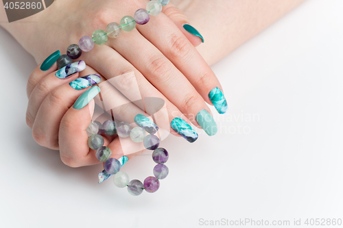 Image of Closeup of woman hands with colorful nails