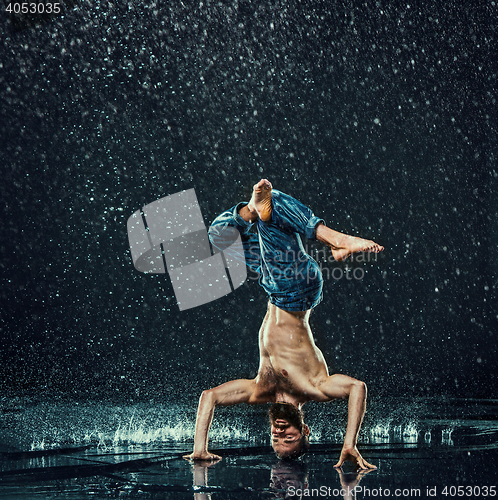 Image of The male break dancer in water.