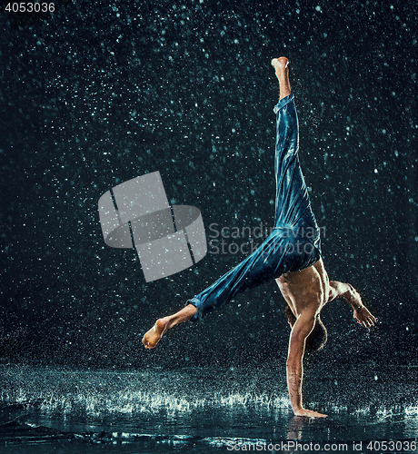 Image of The male break dancer in water.