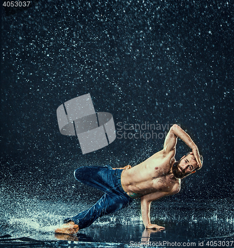 Image of The male break dancer in water.